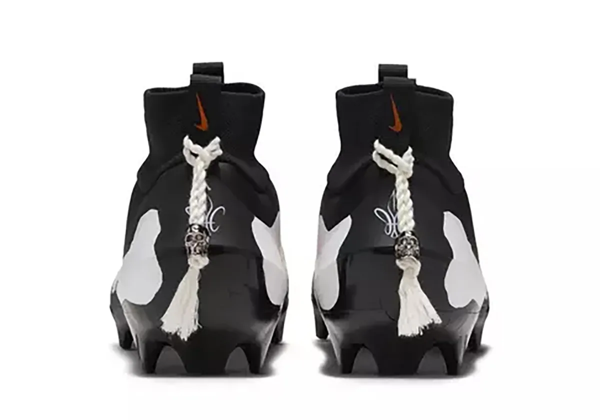 heel view of pair, black collars with skull-charm lace tags and small orange swooshes, Skeleton