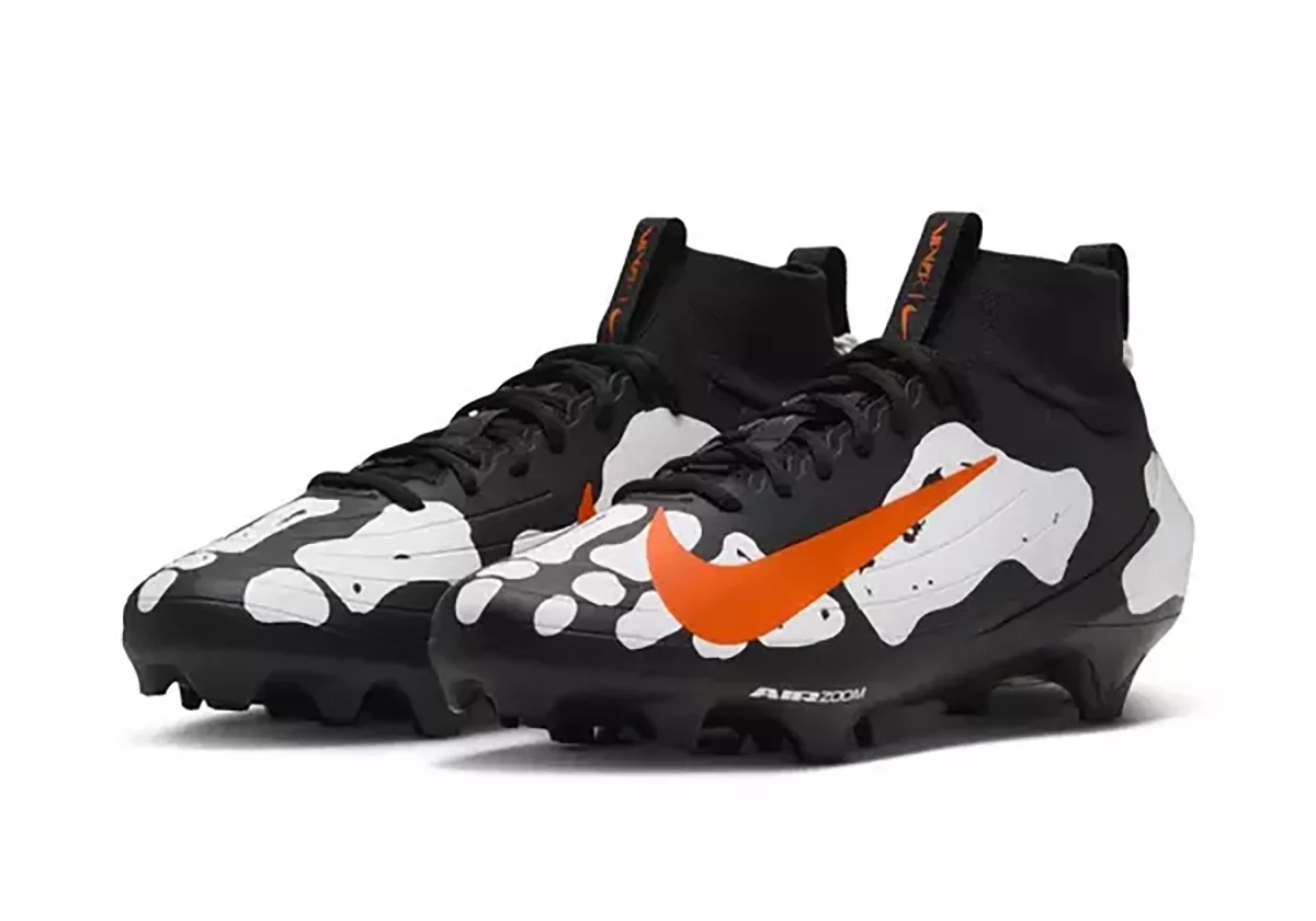 three-quarter pair view, black and white bone-pattern uppers with orange swooshes, Skeleton