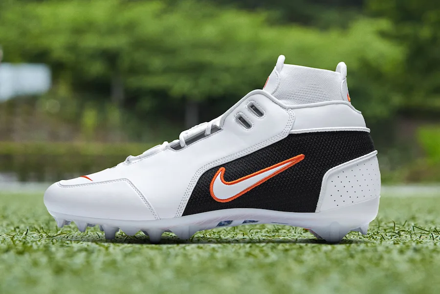 lateral view, white upper with orange-outlined swoosh, black mesh panel, OBJ Uptempo Cleat