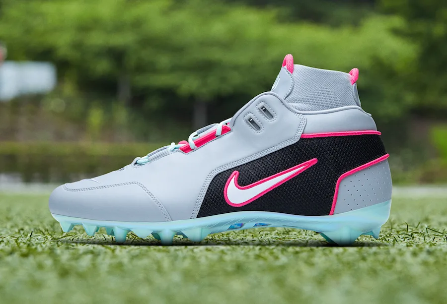 lateral view, grey upper with pink-trimmed black swoosh panel, mint outsole, OBJ Uptempo Cleat