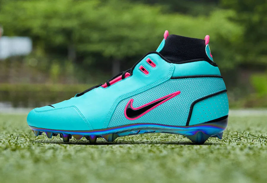 lateral view, teal upper with pink swoosh, iridescent outsole, OBJ Uptempo Cleat
