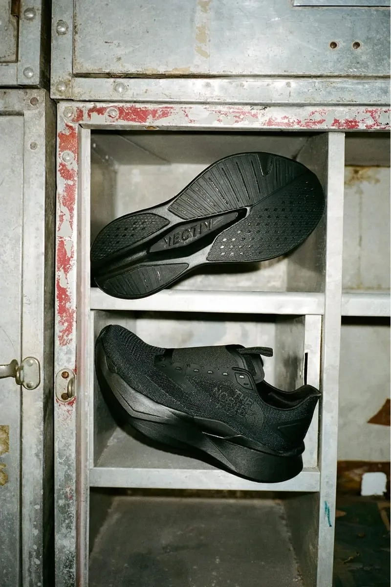 single shoe on rusty metal shelving with outsole shown above, VECTIV text on sole, Garments VECTIV Forward