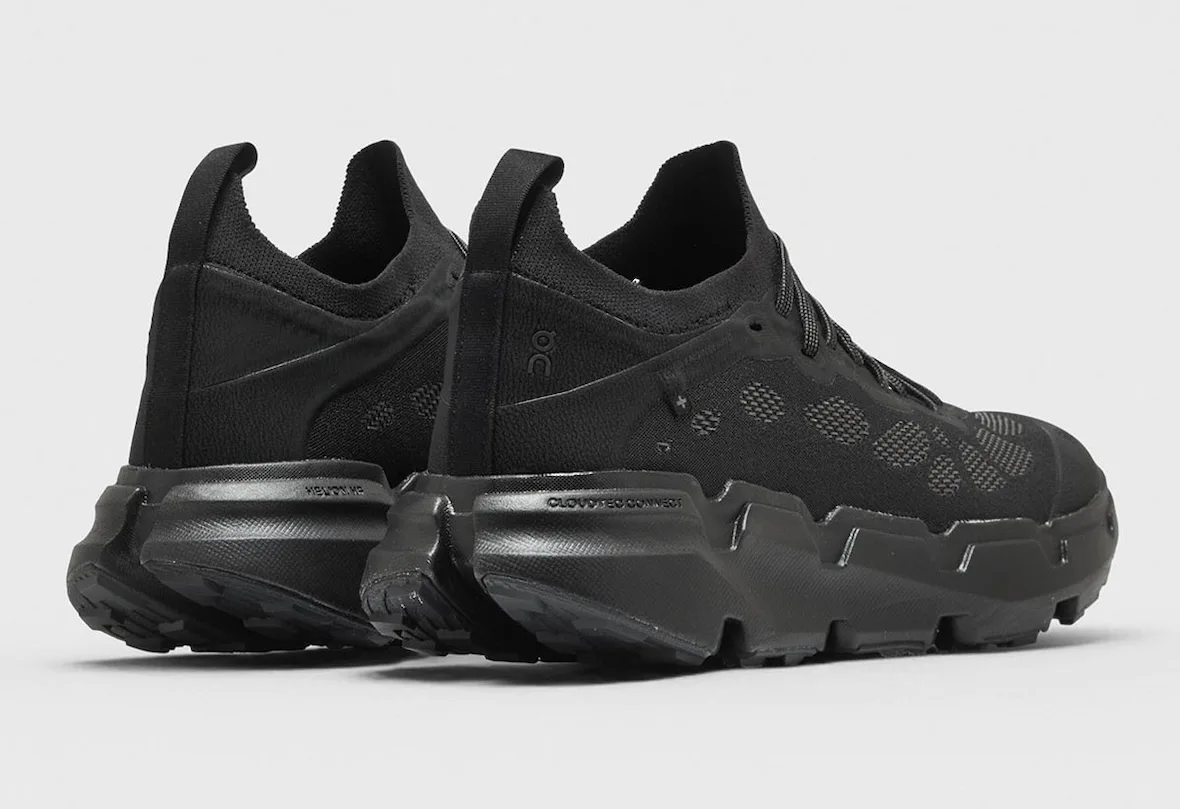 pair, heel-first three-quarter view in all-black showing on logo, POST ARCHIVE FACTION