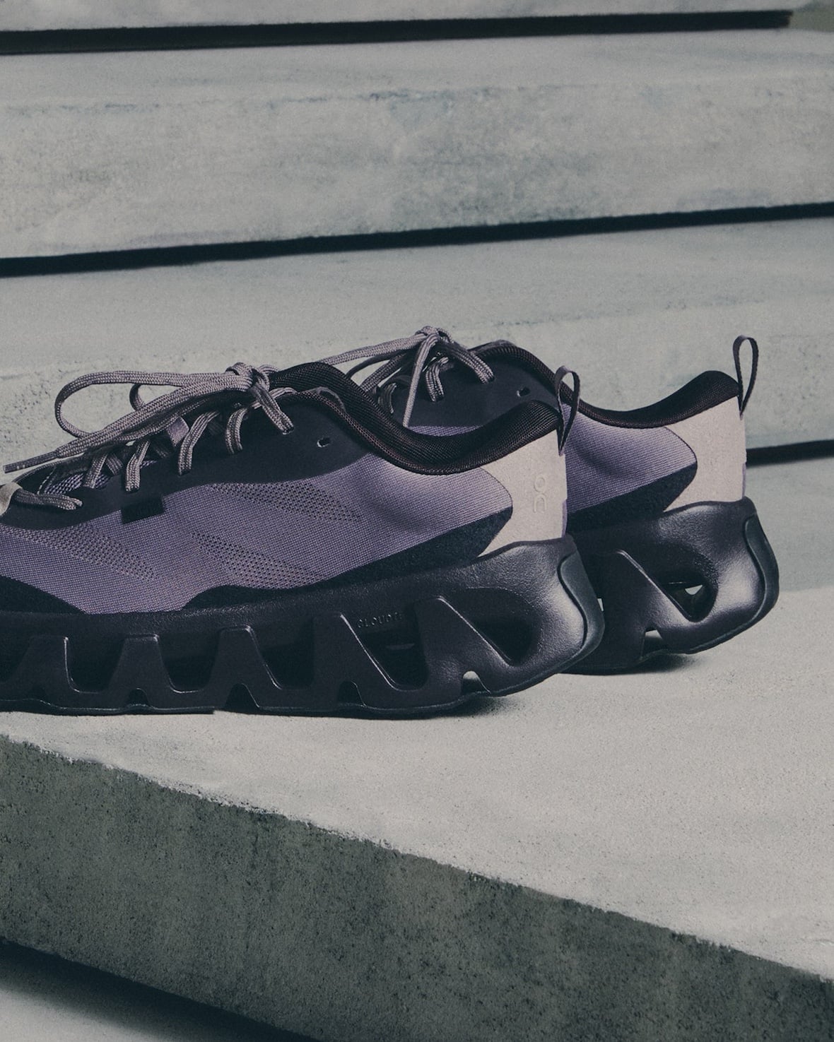 lateral pair, purple mesh upper with black cutout outsole on concrete steps, K Tech 3