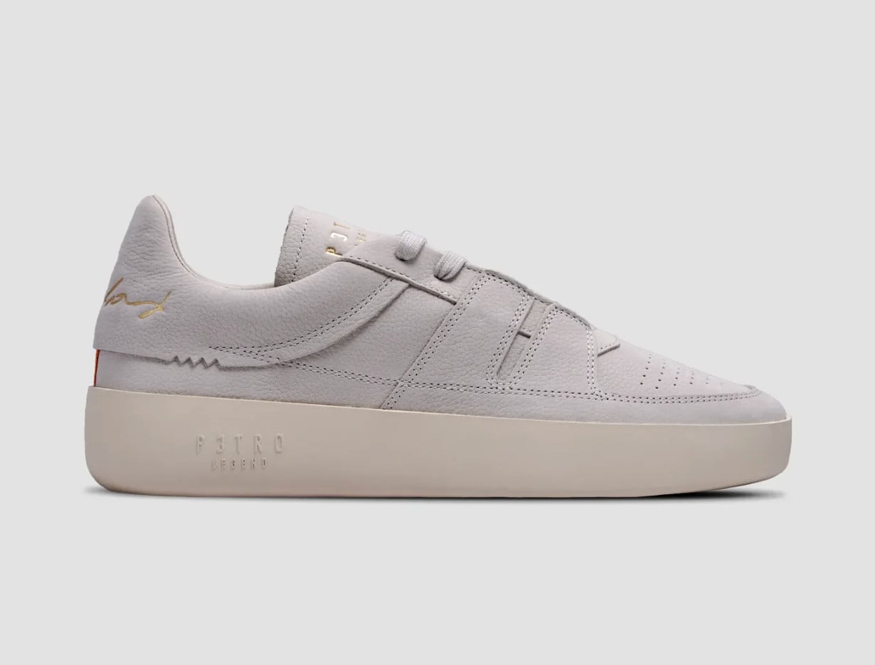 Lateral view, light grey nubuck upper, gold signature logo, cream embossed sole, P3TRO Legend