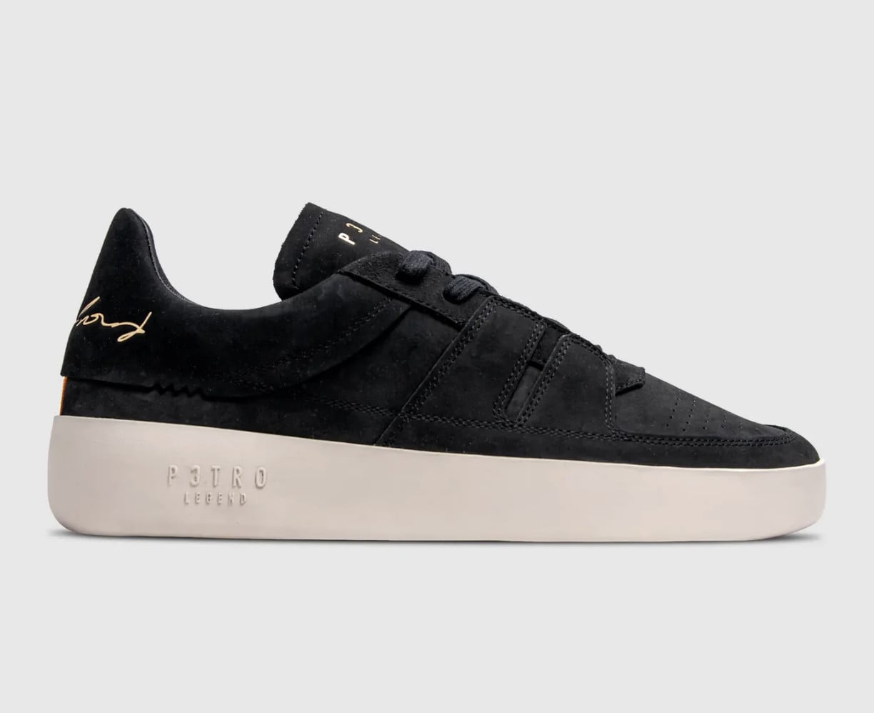 Lateral view, black suede upper, gold signature logo, off-white embossed sole, P3TRO Legend