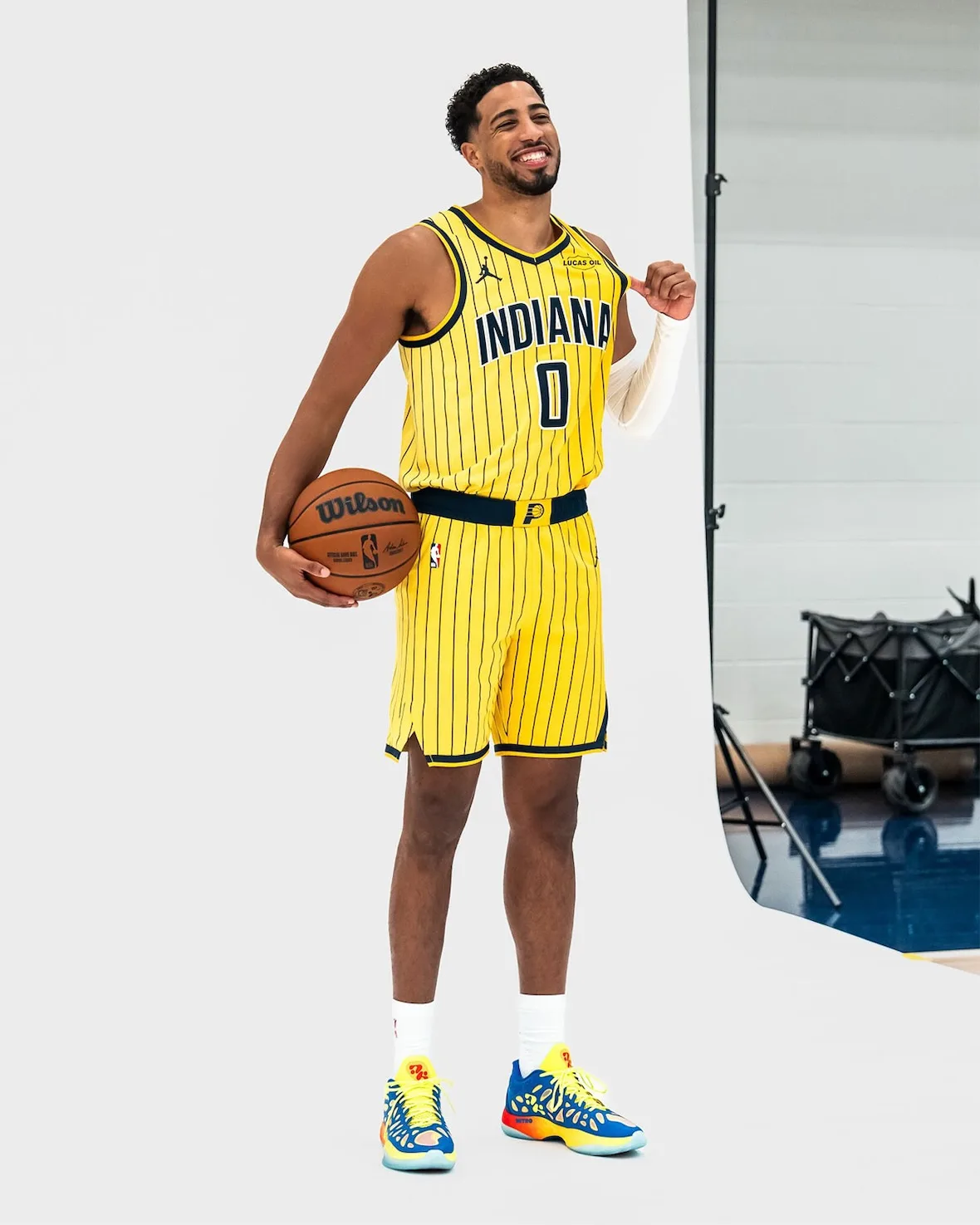 on-foot full-body shot, player smiling in yellow jersey, blue and yellow cutout sneakers, Thermal Vision