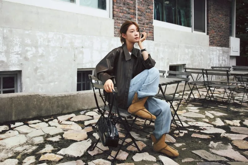 on-foot, tan pair worn with jeans, seated on outdoor metal chair by brick wall, Puma Slipcat Boots