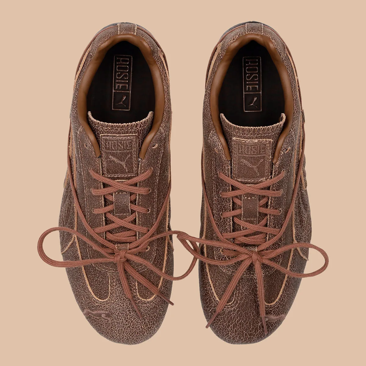 top-down brown pair showing rosie-branded tongue tags and puma logo, OG x Rosé