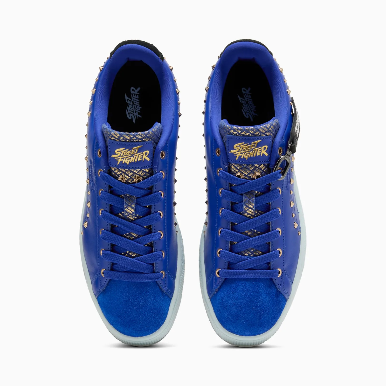 top-down pair view of gold Street Fighter tongue logos and studded blue toes, Chun Li