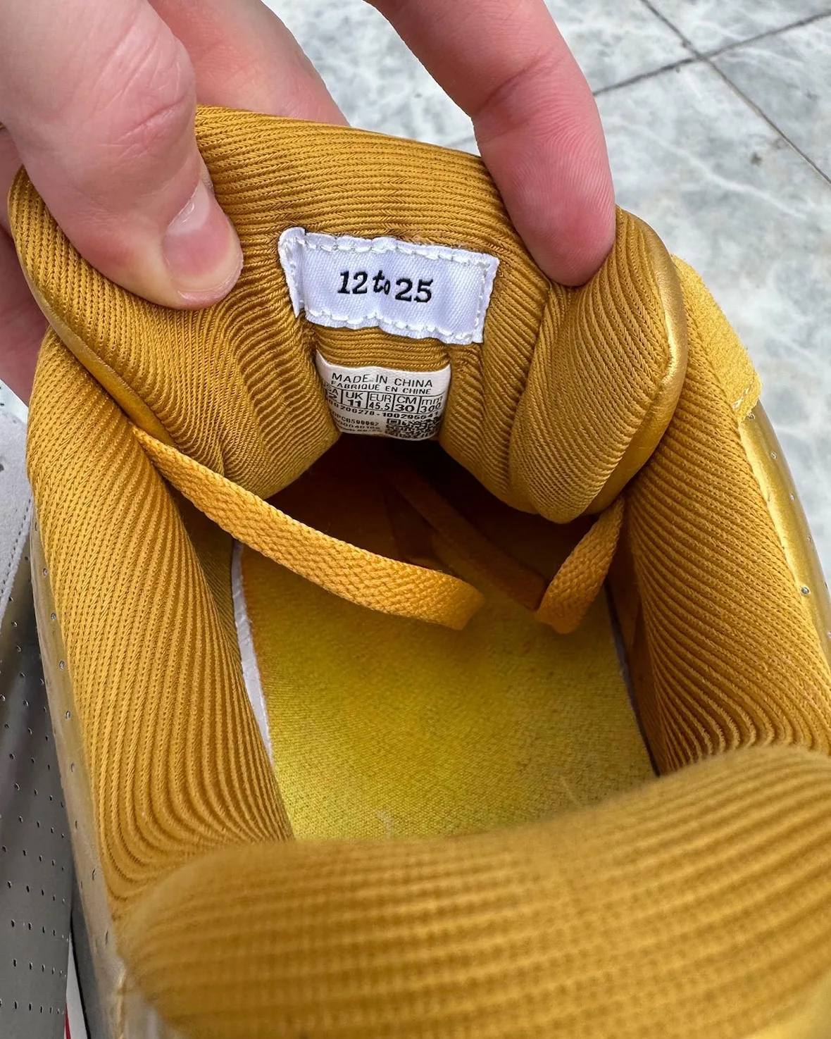 in-hand tongue label reading '12 to 25' with made in china tag, gold shoe, Japanese Beer Pack