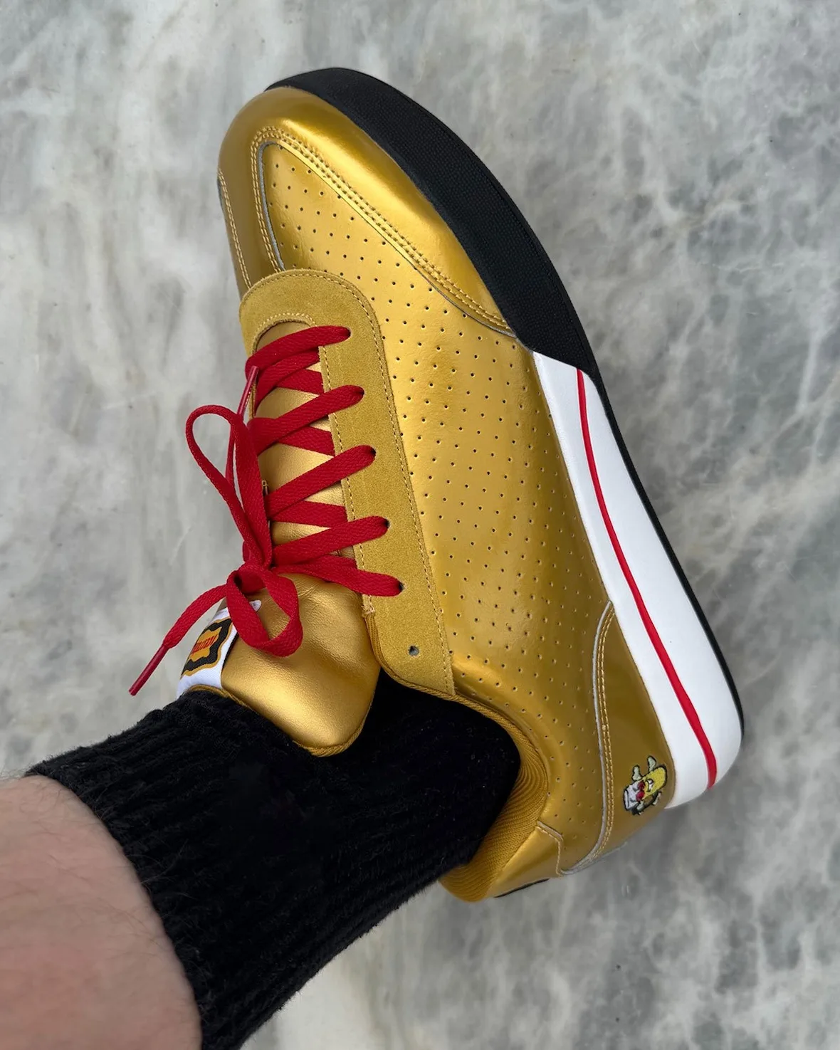 on-foot heel angle, gold sneaker with red laces, red-white-black outsole, Japanese Beer Pack