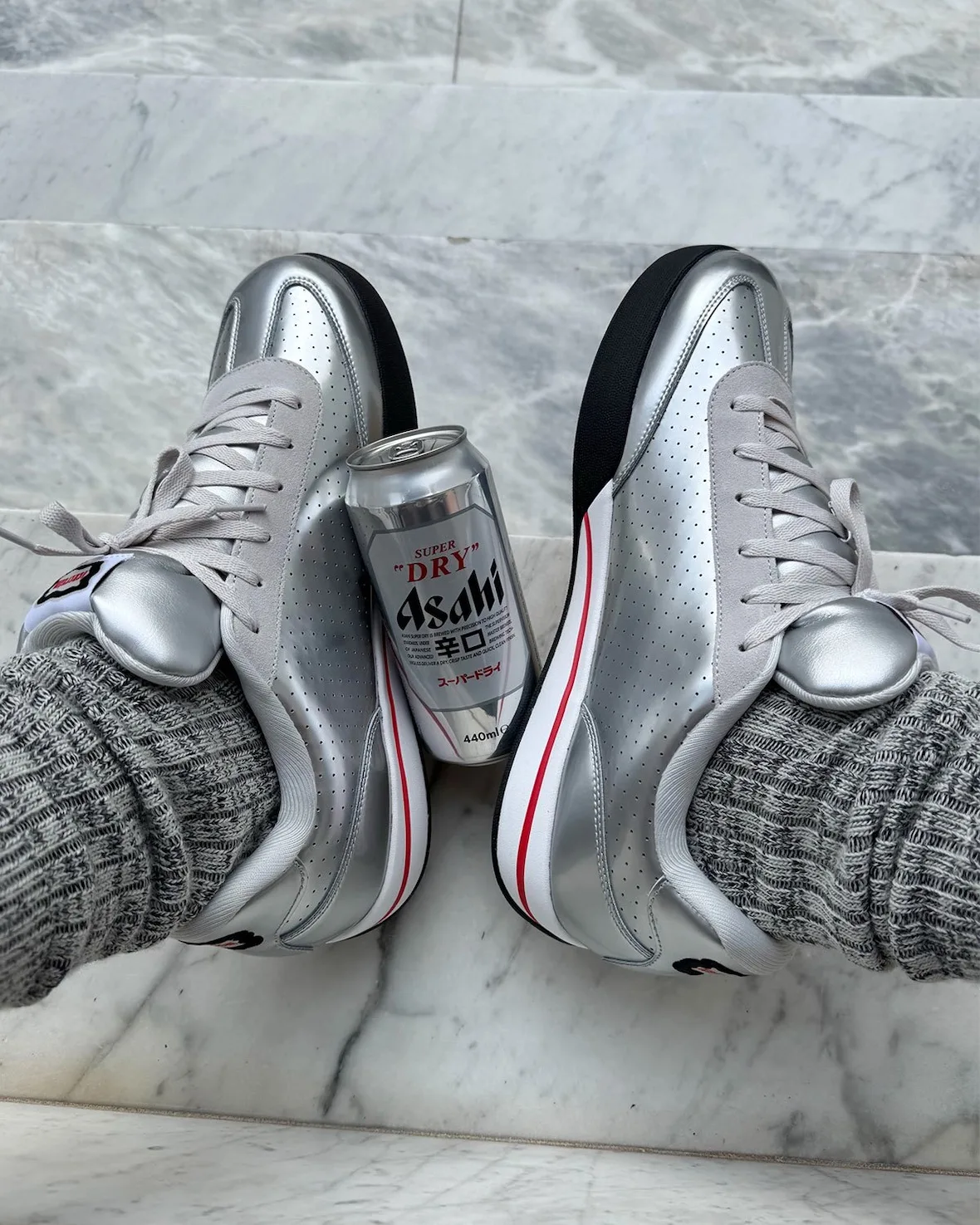 heel view, silver pair on foot with an Asahi beer can wedged between heels, Japanese Beer Pack