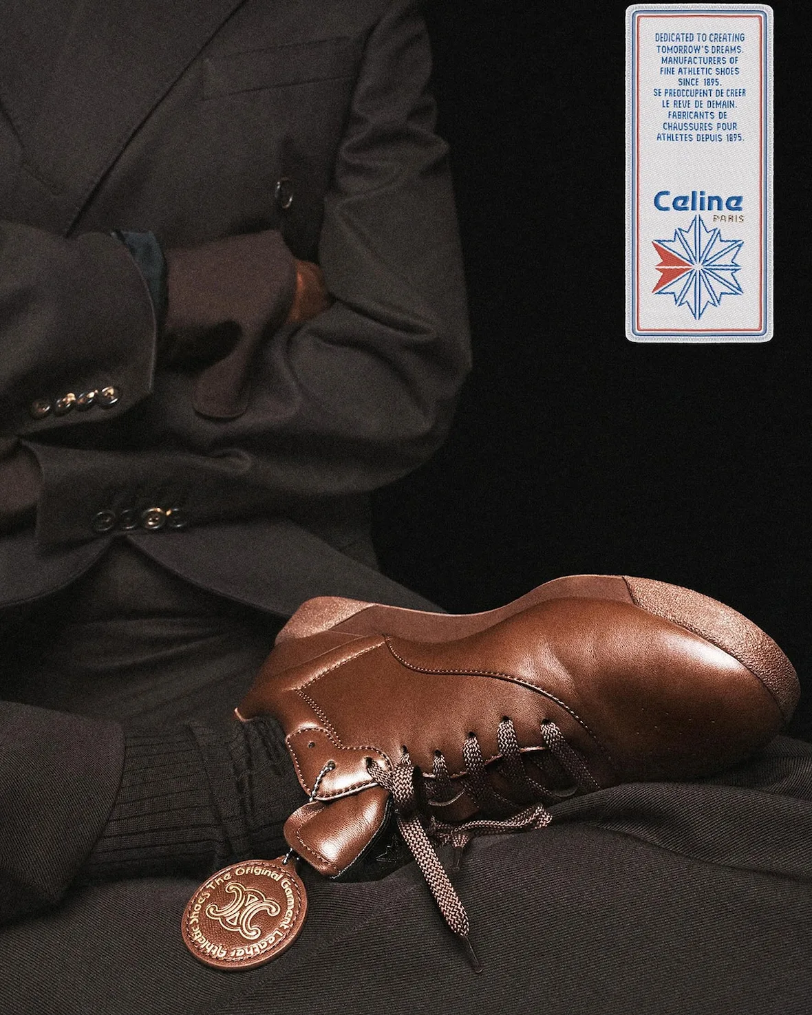 In-hand detail, brown leather sneaker with circular leather hangtag, Lo x Celine
