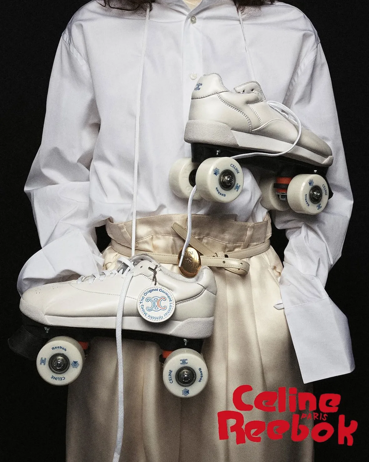 In-hand pair, white roller skates with Celine-branded wheels, Lo x Celine