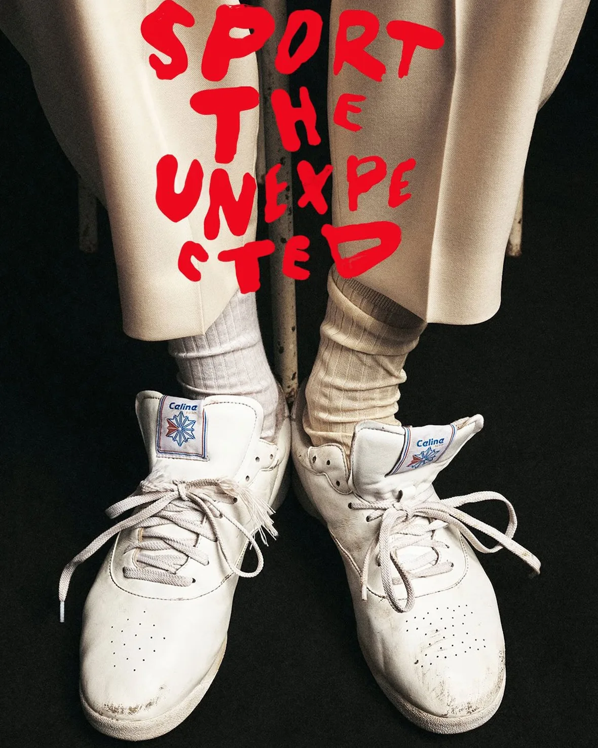 On-foot pair, cream sneakers with red 'Sport the unexpected' text, Lo x Celine