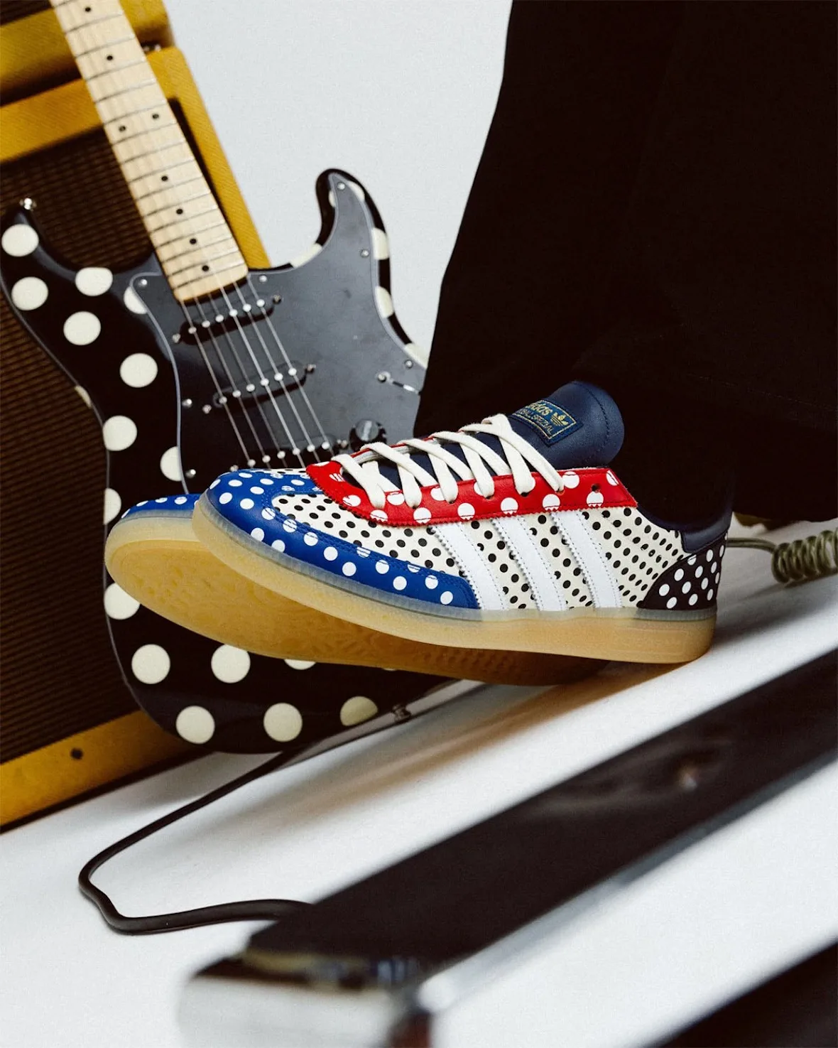 on-foot lateral close-up beside polka-dot guitar, navy heel tab, gum sole, Polka Dot