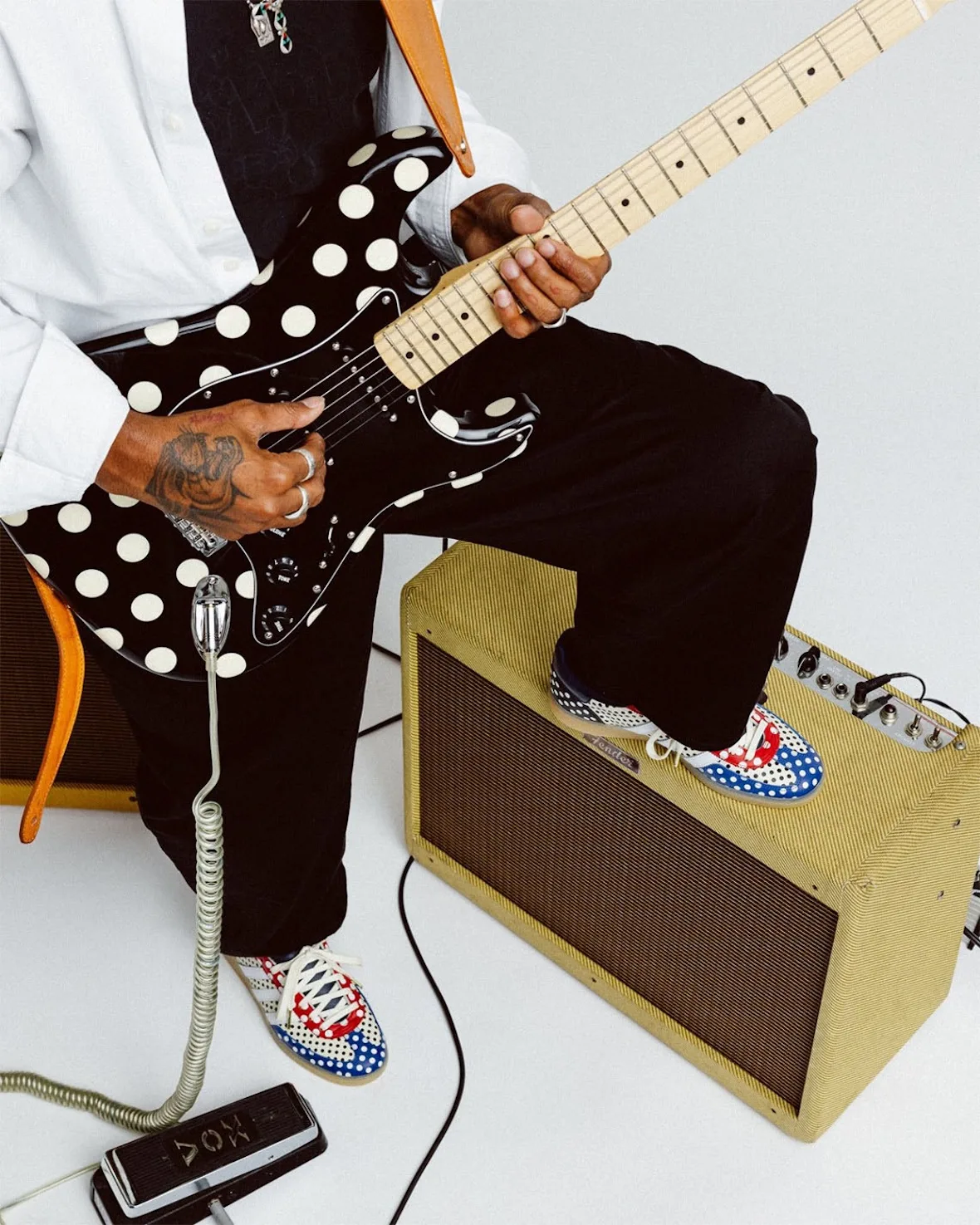 on-foot lateral view atop amp with polka-dot guitar, red white blue dot panels, Polka Dot