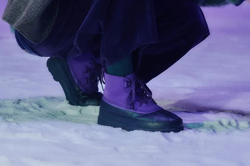 On-foot side view walking in snow, purple duck boots with dark laces, NEEDLES Ambler Collection