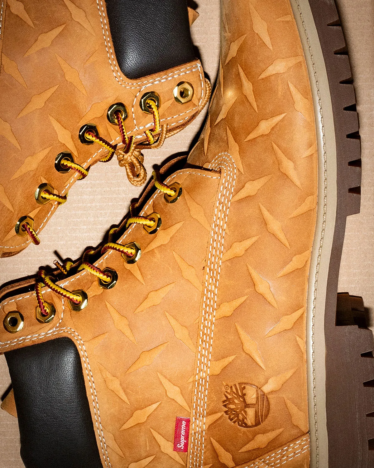 detail of wheat diamond-plate leather with brass eyelets and lug outsole, Premium Waterproof Boot