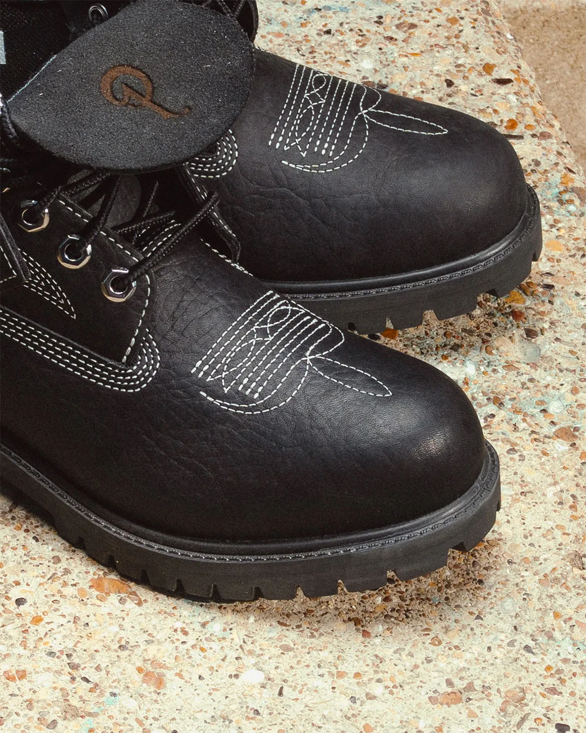 toe close-up of black pair showing stitching and Sneaker Politics tag, x Sneaker Politics