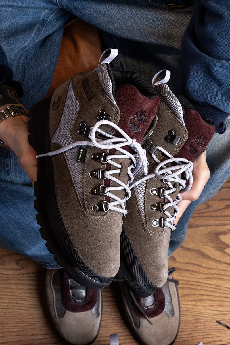 Pair held in hands with another pair resting below on a wood floor, Euro Hiker GTX