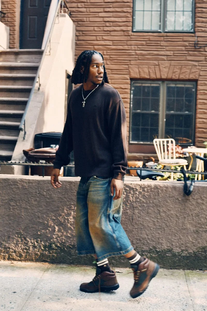 on-foot side view, man walking, brown boots with green panels visible, Timberland Field Boot