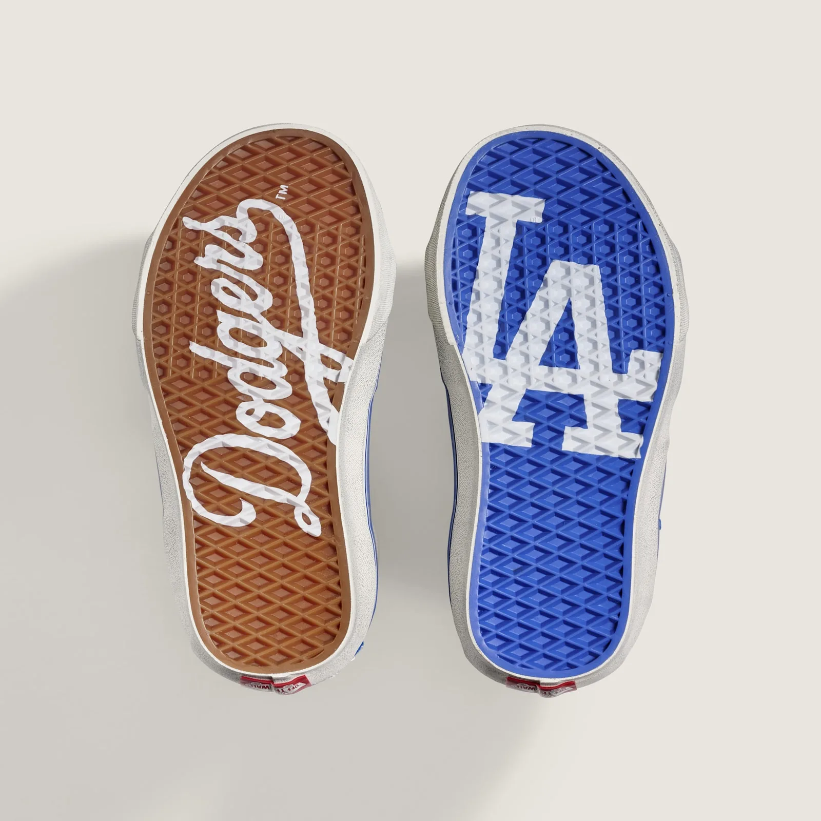 outsoles side by side, brown Dodgers script and blue LA logo, Los Angeles Dodgers