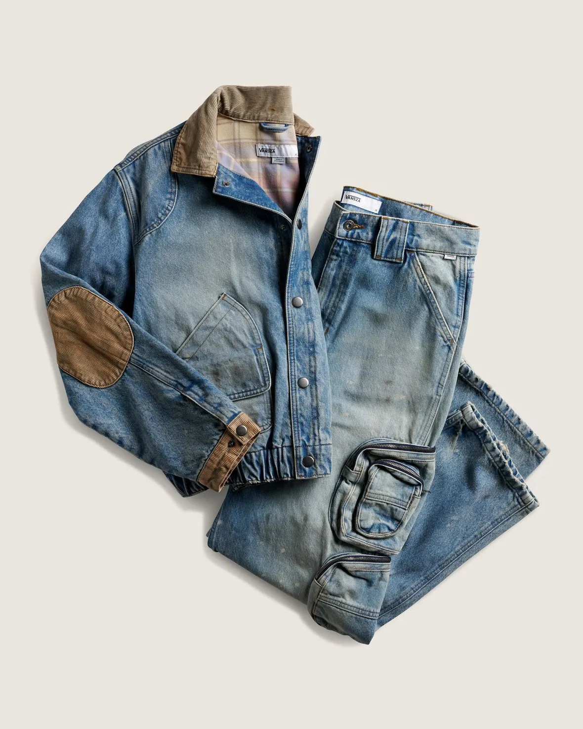 flat lay of distressed denim jacket and jeans with tan corduroy trim, SZA VANSZA Collection
