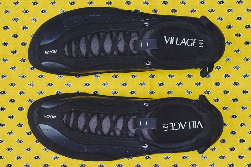 top-down pair view, black shoes with VILLAGE PM text, yellow patterned fabric, VILLAGE PM 2PM