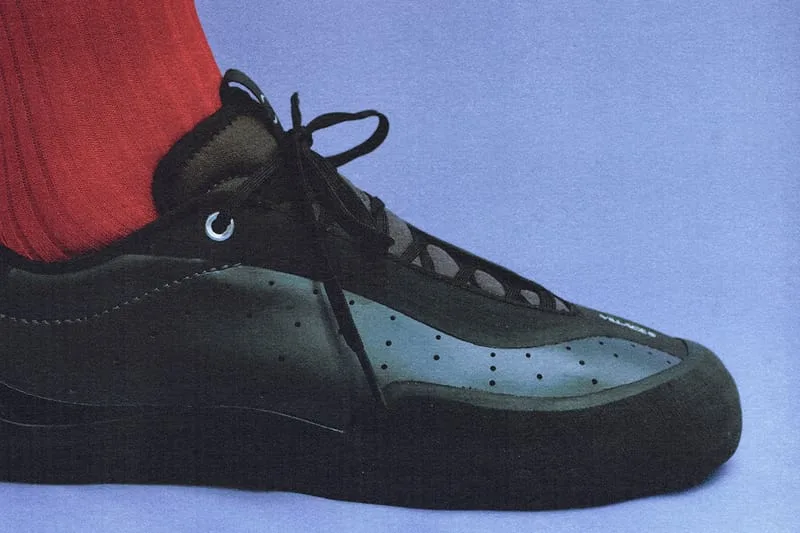 on-foot medial close-up, black shoe with teal dotted toe panel, red sock, VILLAGE PM 2PM