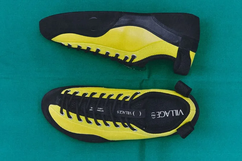 lateral and outsole view, yellow and black suede pair on teal fabric, VILLAGE PM 2PM