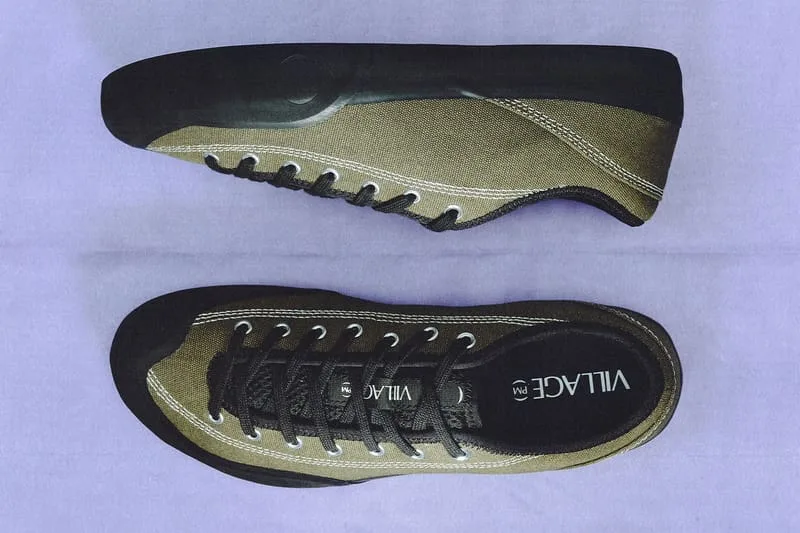 lateral and outsole view, olive canvas with black toe and heel, VILLAGE PM text, VILLAGE PM 2PM