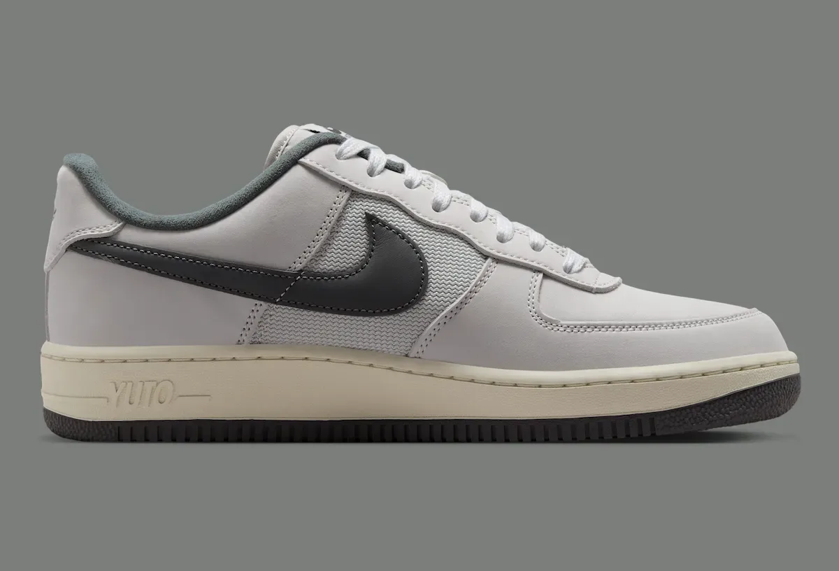 lateral view, grey leather upper with YUTO text embossed on the cream midsole, Iron Grey