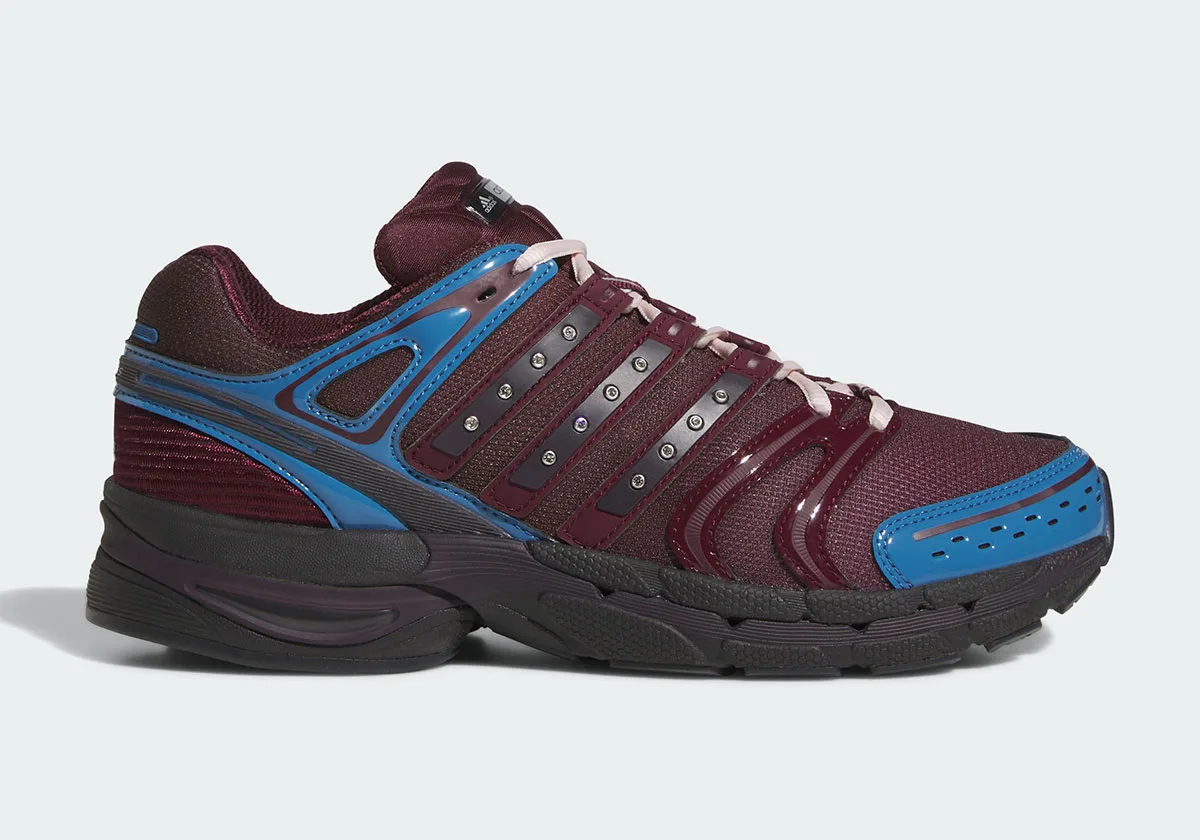 Lateral view of maroon sneaker with blue overlays, studded dark straps and black sole, 5 x Hardies