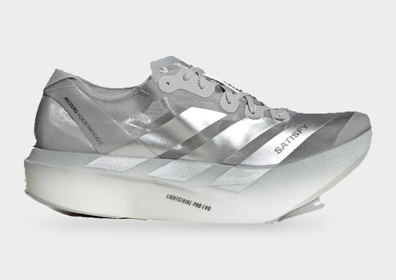 Lateral view of silver sneaker with translucent upper, SATISFY text and white, adidas Adizero Adios Pro Evo 2 x Satisfy