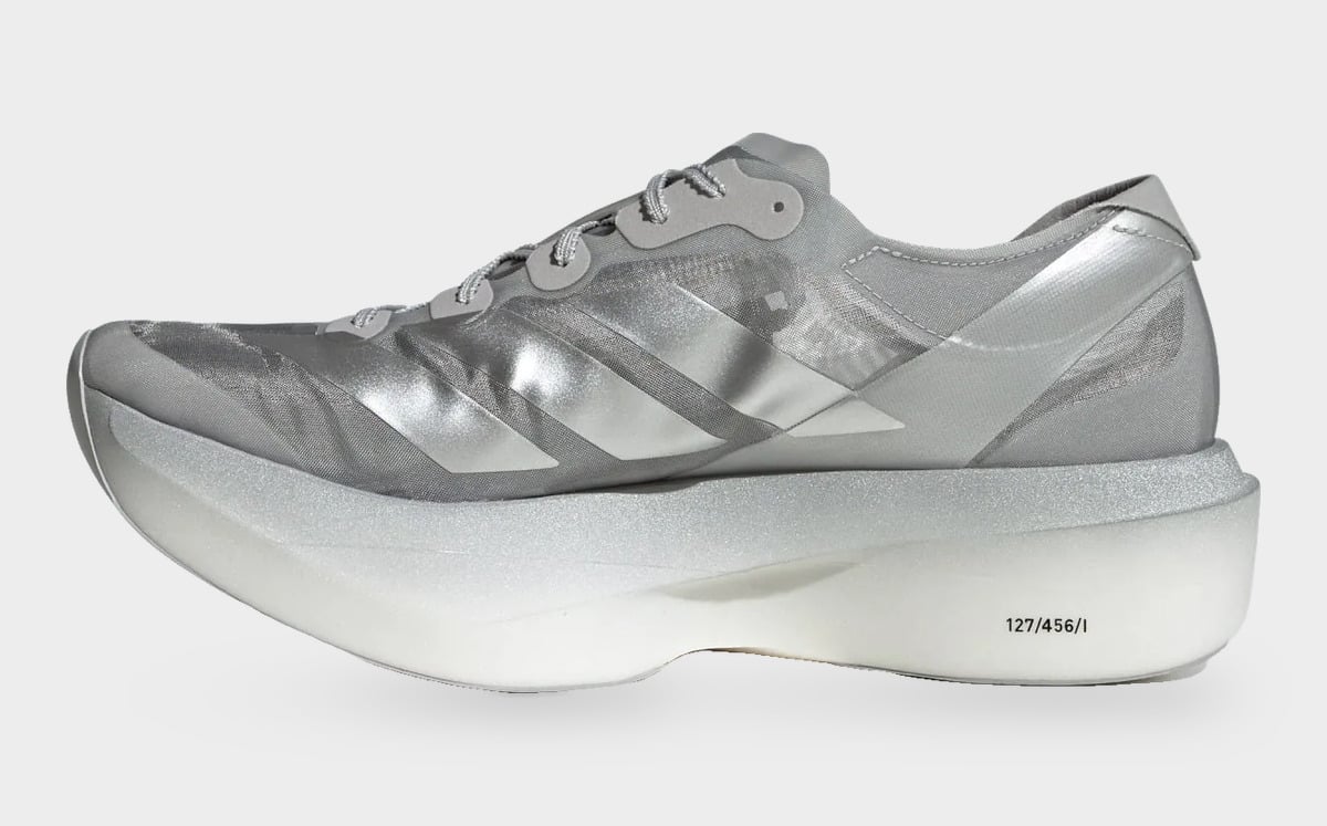 Medial view of silver shoe with thick midsole and 127/456/I printed on the foam, 2 x Satisfy