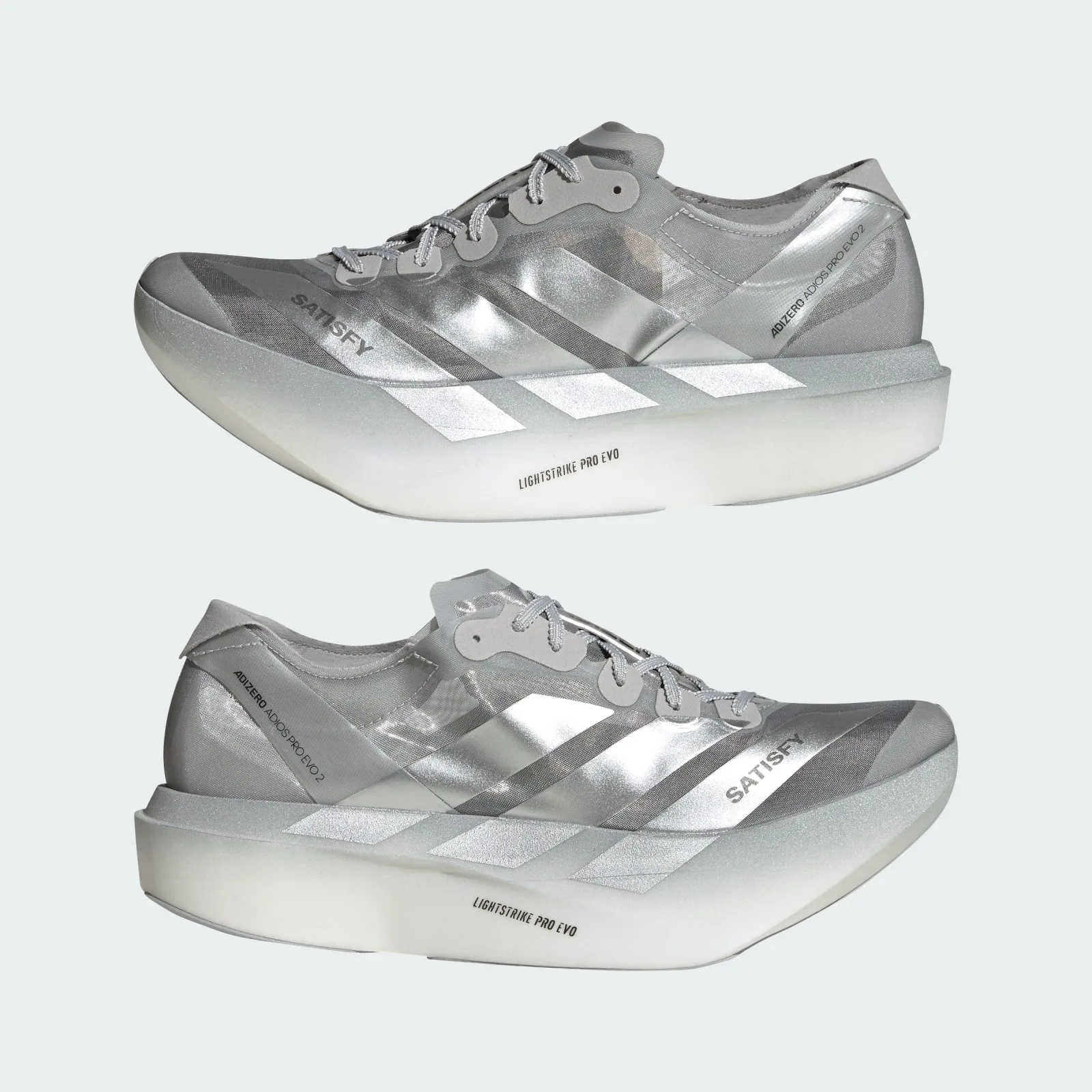 Pair in lateral and medial view, silver stripes on thick white-to-silver midsole, 2 x Satisfy