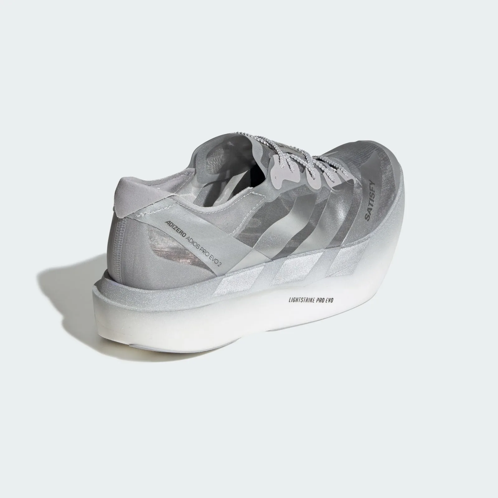 Heel-angled view on pale background, silver stripes and Lightstrike Pro Evo midsole text, 2 x Satisfy