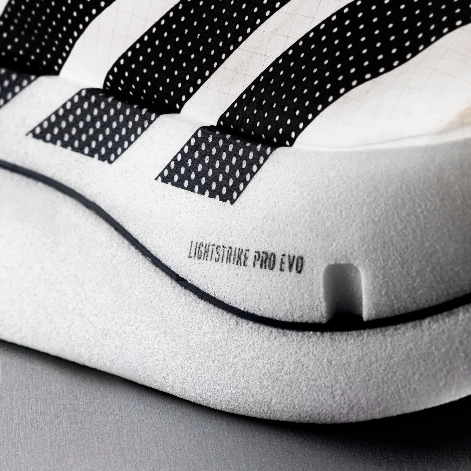 Close-up of white midsole foam with Lightstrike Pro Evo text, black dotted stripes and a notch, Pro EVO 3