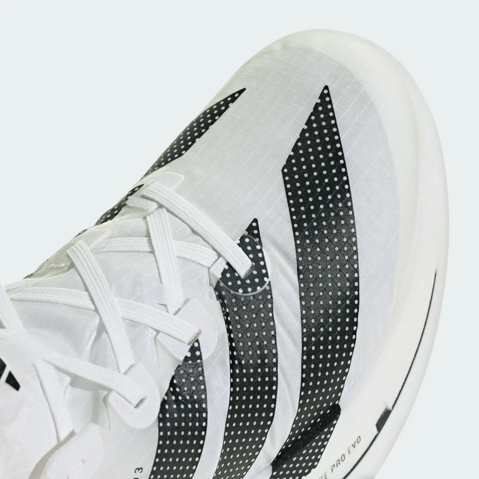 Close-up of toe box, black dotted stripes, white laces and ripstop-grid white upper, Pro EVO 3