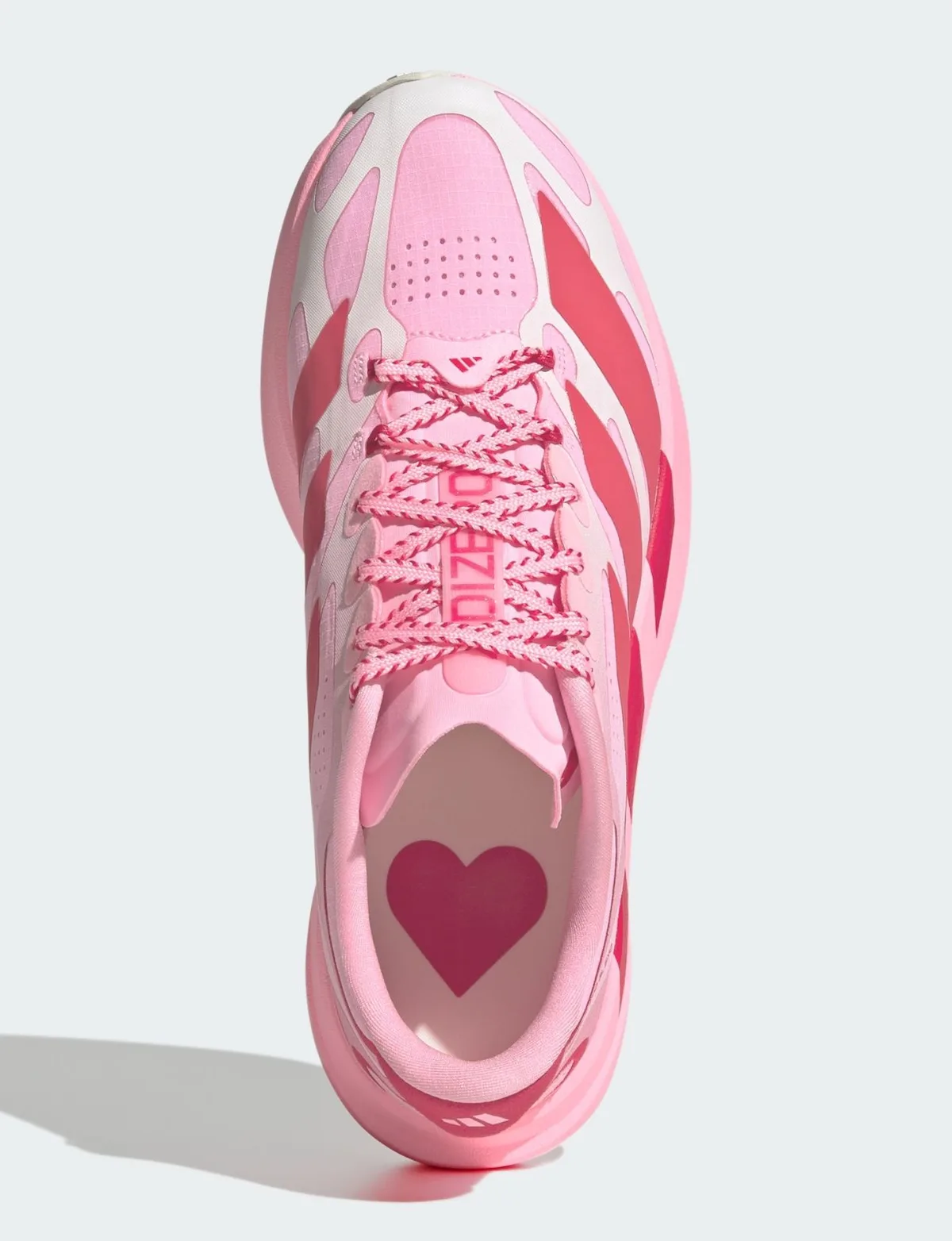 Top-down view with a large red heart on the insole, pink striped laces and white toe overlays, Pink Glow Hearts