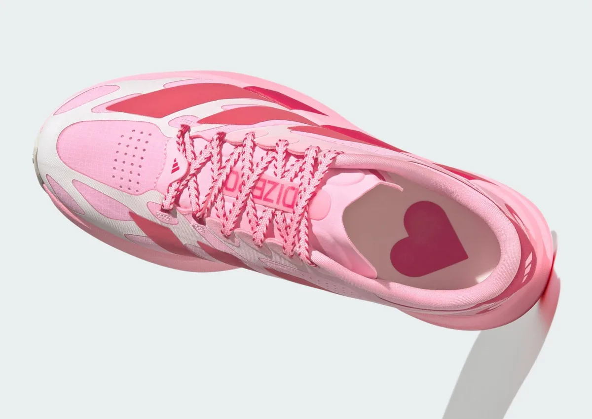 Top-down angled view with a red heart printed on the pink insole and striped laces, Pink Glow Hearts