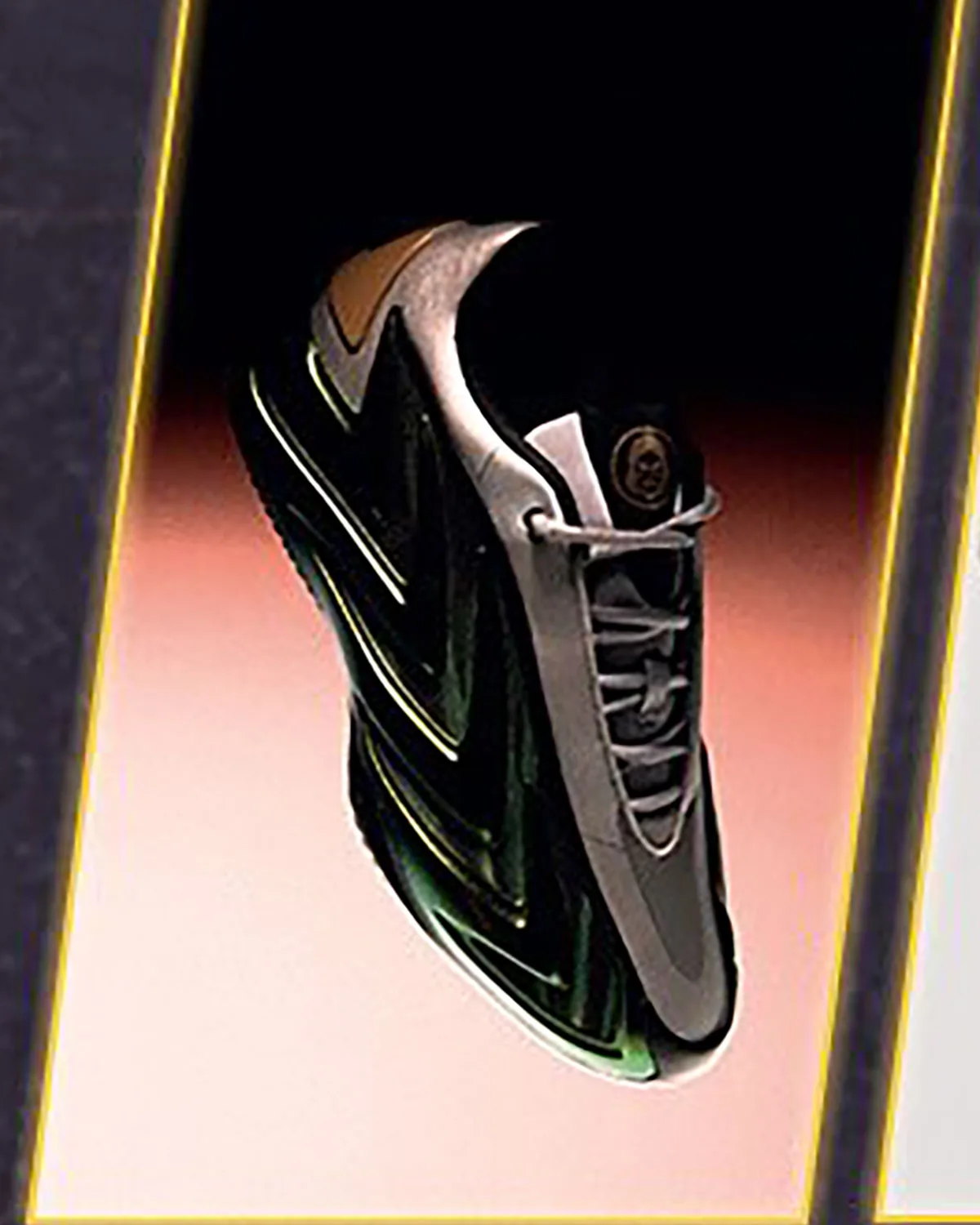 Angled heel-to-toe view of a floating sneaker with grey laces, gold circular badge and green glossy midsole, yellow-trimmed