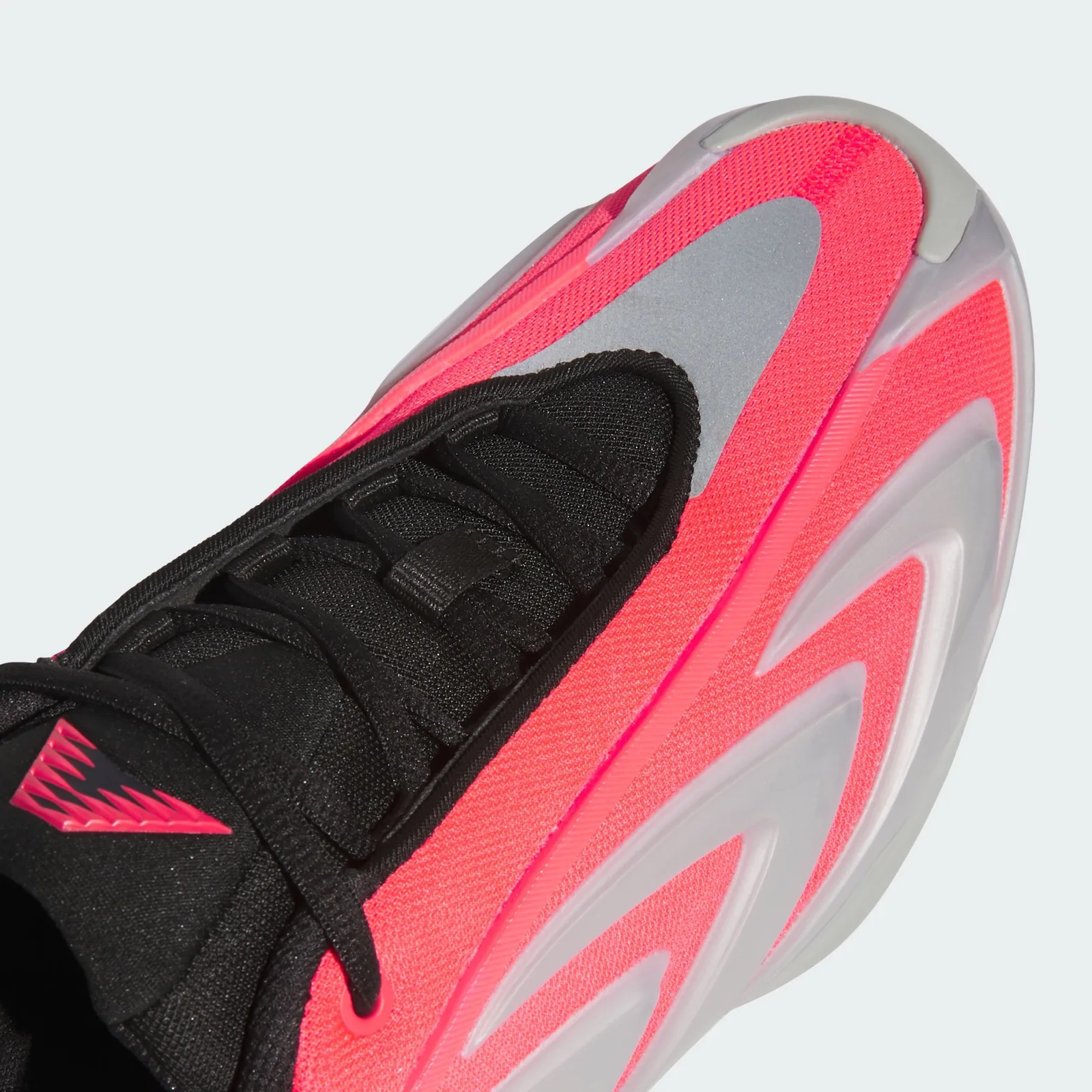 Close-up of black lacing, red mesh, silver toe panel and chevron overlays, Omen