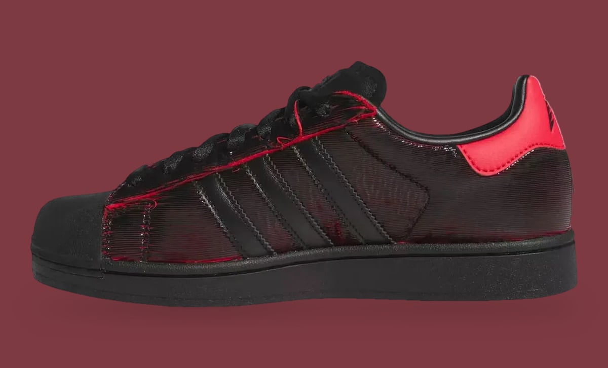 Lateral view, black three stripes on ridged upper with red stitching and a bright red heel tab, Halloween