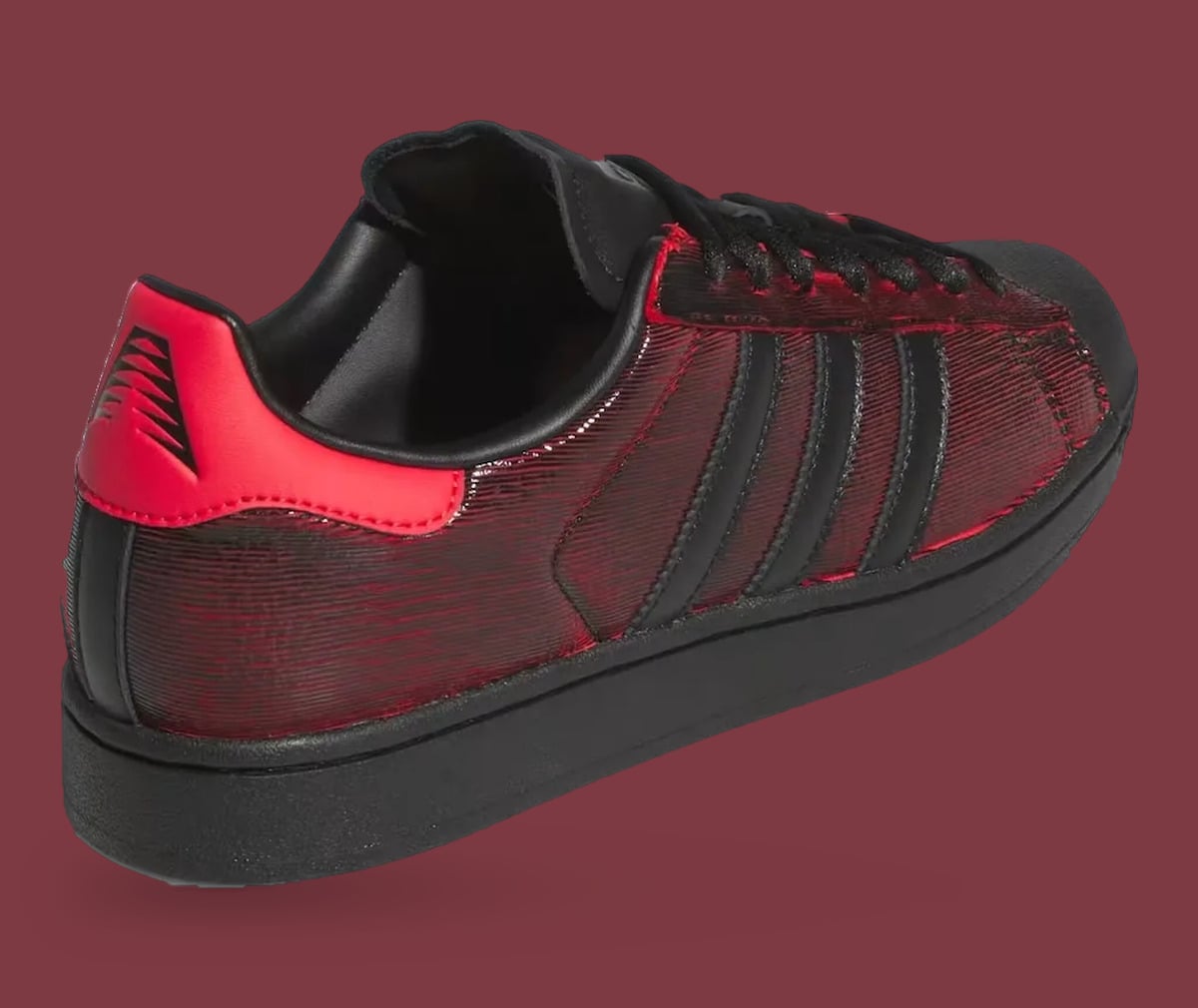 Heel and lateral quarter: red heel tab with black claw-mark logo, ridged black-red upper, Halloween