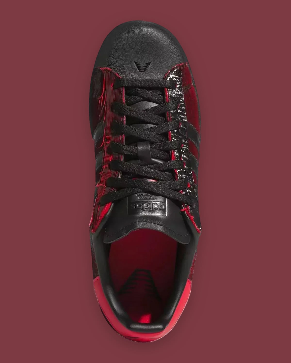 Top-down view: black laces, red insole with black logo, adidas tongue label, red heel tab, Halloween