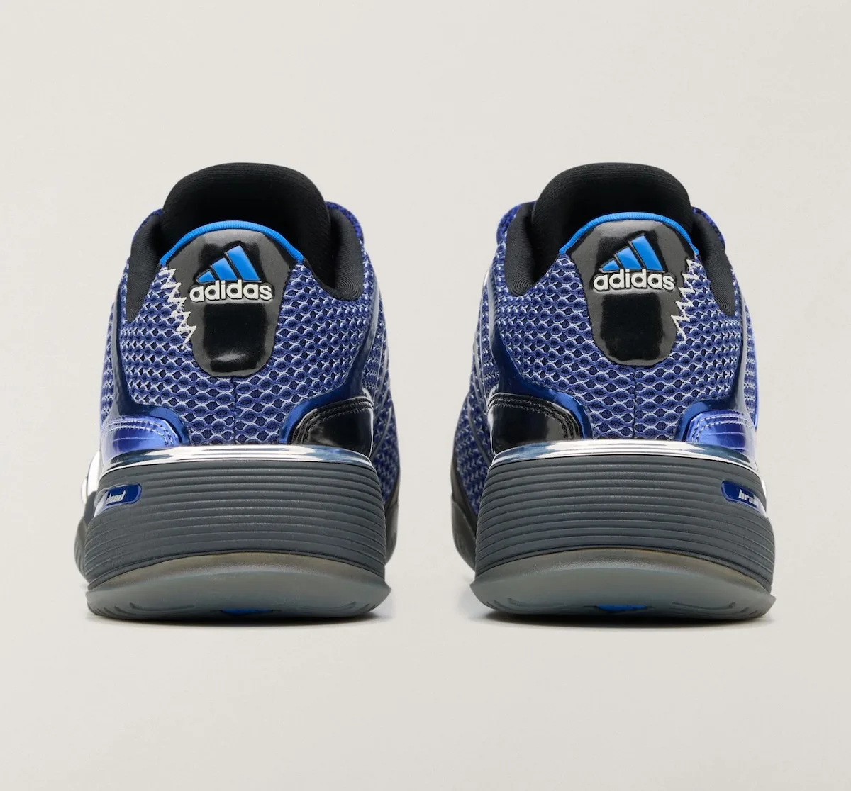 Heel view of pair, blue mesh with black heel tab, adidas logo and zigzag stitching, x Brain Dead