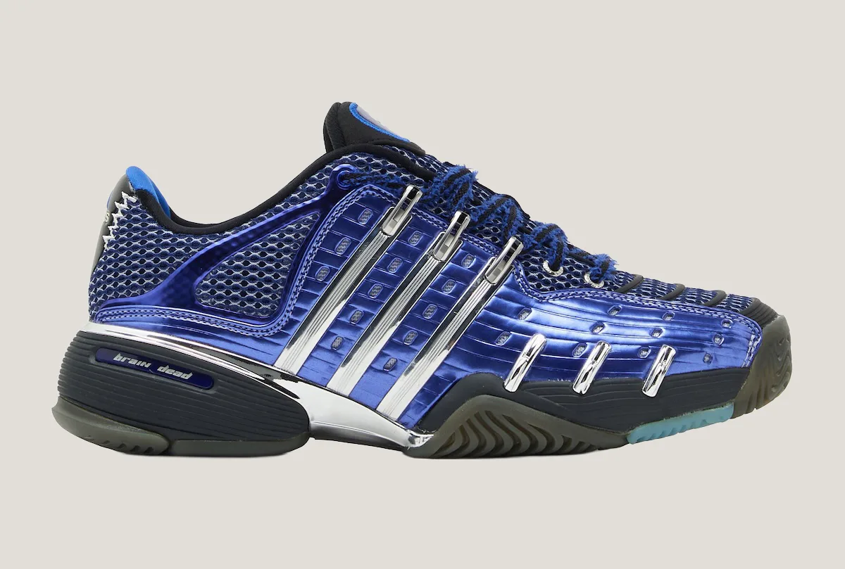 Lateral view of blue metallic shoe, chrome stripes, frayed laces, brain dead text on heel, x Brain Dead